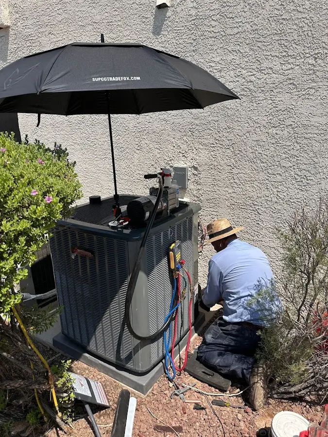 HVAC technician performing outdoor AC maintenance in Forestville
